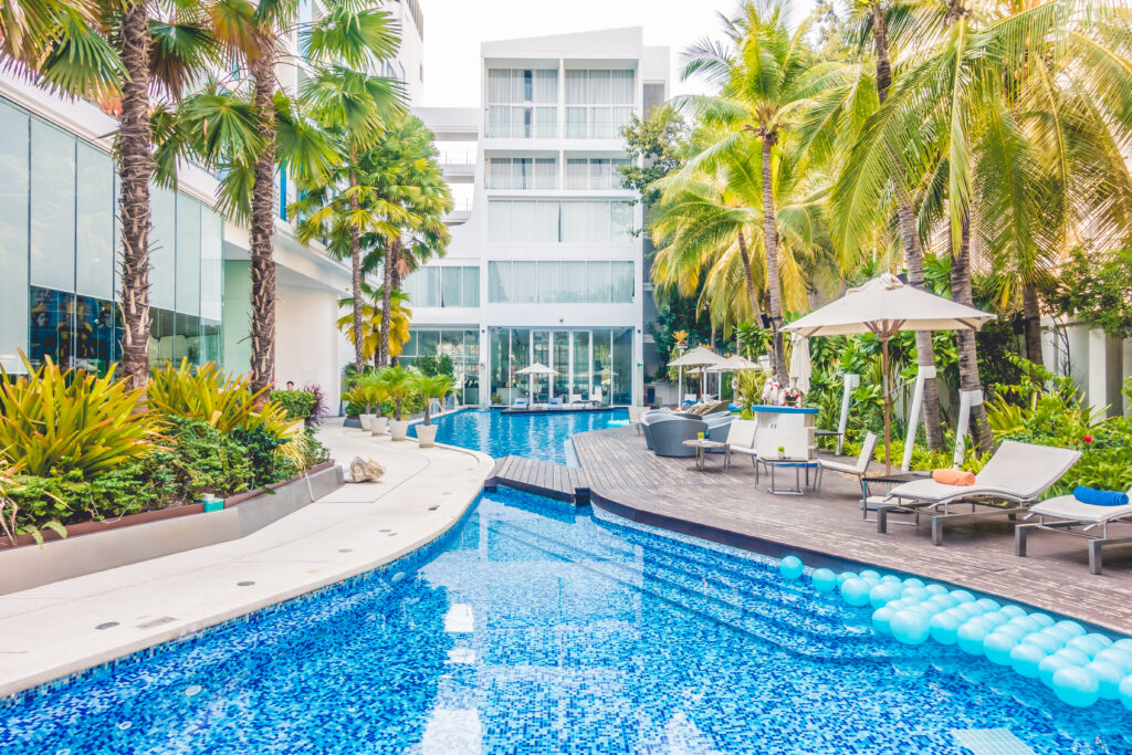 Umbrella pool and chair around beautiful luxury swimming pool in hotel resort - Vintage Light film Filter